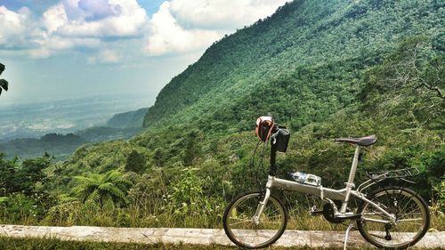 Bicycle on mountain against sky