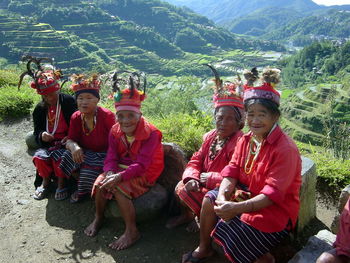 Rear view of people sitting on mountain road