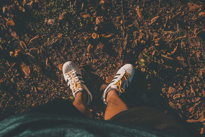 Low section of man standing on ground