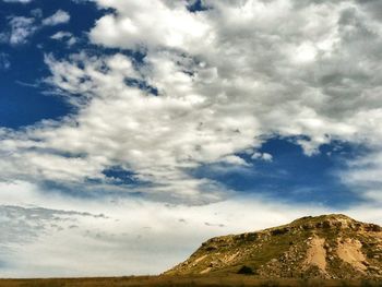 Scenic view of mountains against cloudy sky