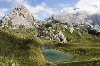 Scenic view of lake and mountains against sky