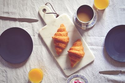 High angle view of croissants and coffee on table