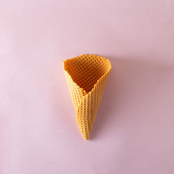 Ice cream cone on lilac pastel background. minimal summer concept. flat lay.