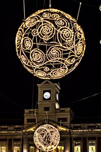 Low angle view of clock at night