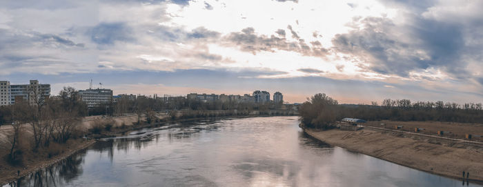 Panoramic view of river and buildings against sky