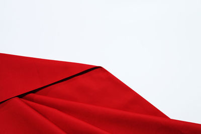 Close-up of red umbrella against white background