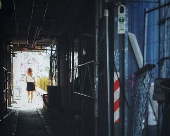 Rear view of woman walking on walkway