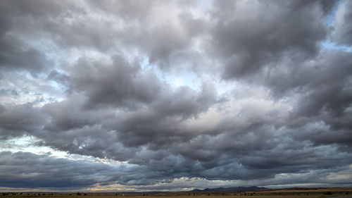 Scenic view of dramatic sky over storm clouds