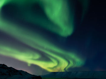 Low angle view of aurora borealis in sky at night