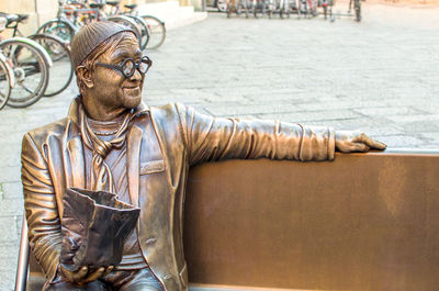 Statue of man wearing animal sculpture