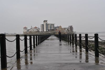 Pier on sea against sky