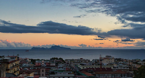 High angle view of townscape by sea against sky