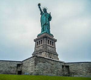 Low angle view of statue against cloudy sky