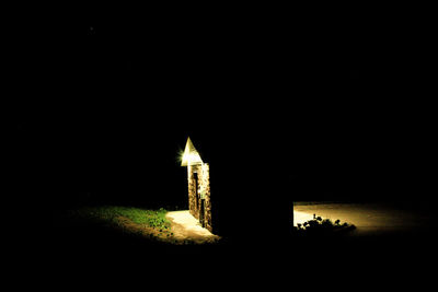 Illuminated built structure against clear sky at night