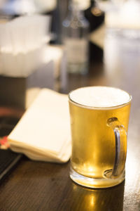 Close-up of beer glass on table