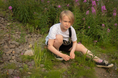 Full length of girl sitting on grass