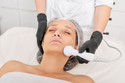 Portrait of smiling young woman exercising in hospital