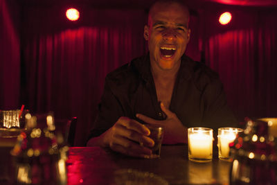 Young man enjoying a drink at a bar