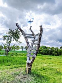 Traditional windmill on field against sky