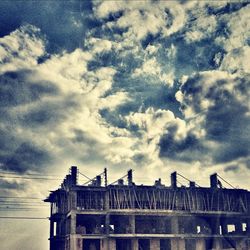 Low angle view of built structure against cloudy sky