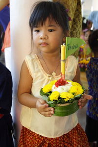 Close-up of girl holding flowers