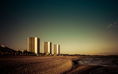 City at waterfront during sunset