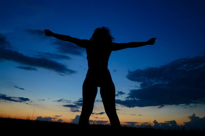 Silhouette man standing against sky during sunset