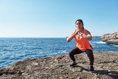 Latin woman, middle-aged, wearing sportswear, training, doing physical exercises,