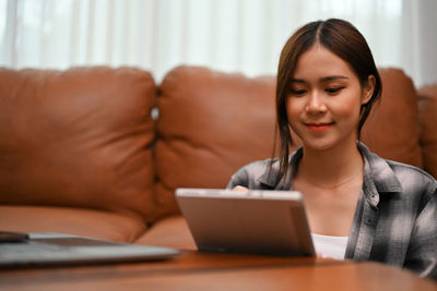 Young woman using laptop at home