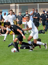 Men playing soccer on field