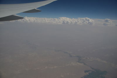 Aerial view of snowcapped mountains against sky