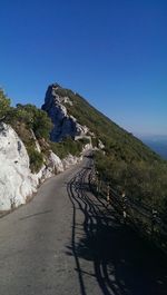 High angle view of mountain road against clear blue sky