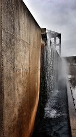 Close-up of water splashing against sky during rainy season