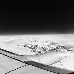 Cropped image of airplane flying over mountain