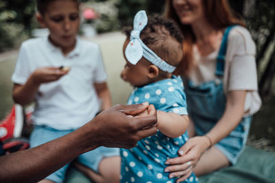 Rear view of father and daughter holding hands