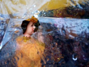 Goddess sculpture seen through plastic