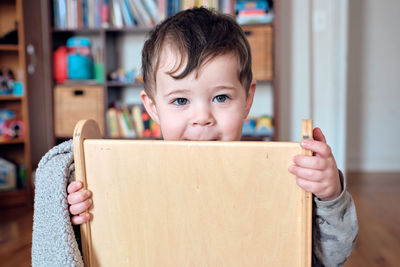 Young boy toddler is playing with his chari and making funny faces