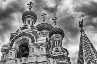 Low angle view of buildings against cloudy sky