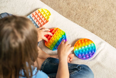 High angle view of woman holding toy