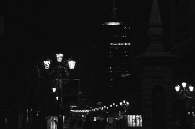 Low angle view of illuminated buildings against sky at night