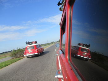 Red car on road against sky