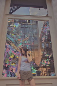 Woman standing by window in store