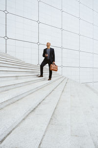 Low section of man walking on street