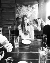 Young woman sitting at restaurant table