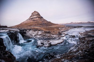 Scenic view of waterfall against sky