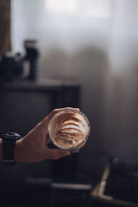 Close-up of hand holding coffee