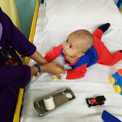 High angle view of boy lying on bed at home