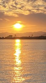 Scenic view of sea against romantic sky at sunset