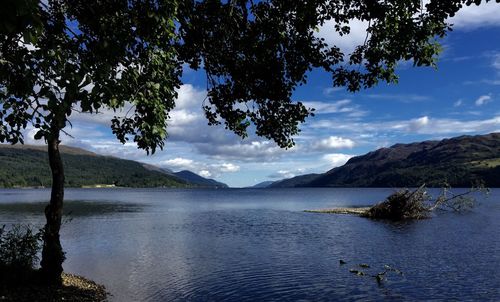 Scenic view of lake against cloudy sky