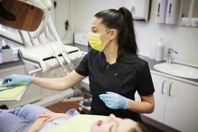 Female dentist with patient in office